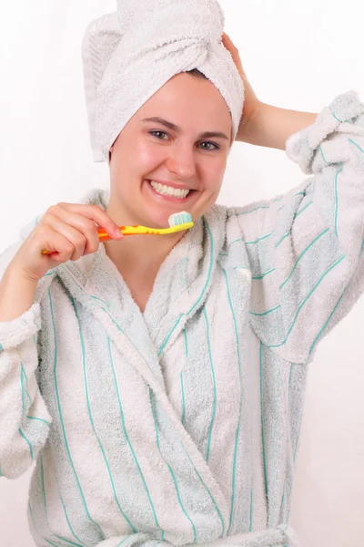 Happy young girl brushes her teeth — Stock Photo, Image