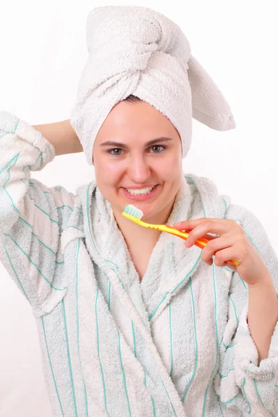 Smiling young girl brushes her teeth — Stock Photo, Image