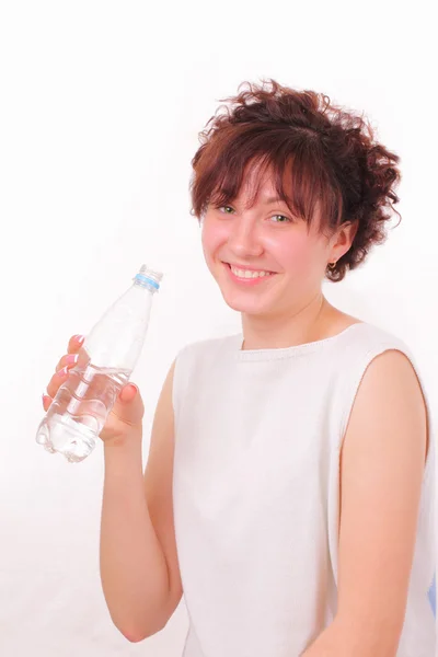 Funny young girl with a bottle of mineral water — Stock Photo, Image