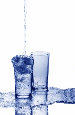 A glass is overfilled with water and an empty glass clipart