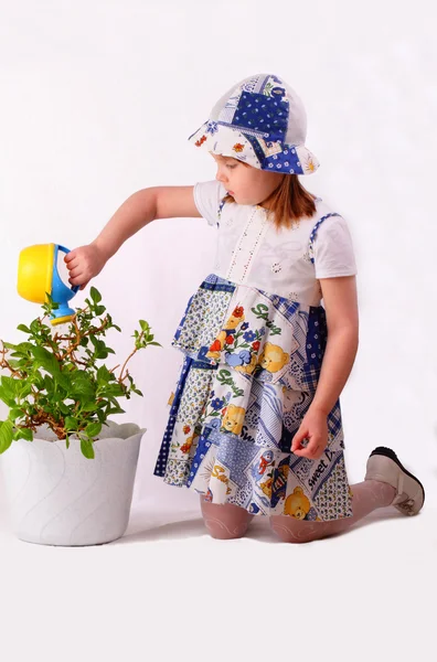 Une petite fille arrose les plantes — Photo