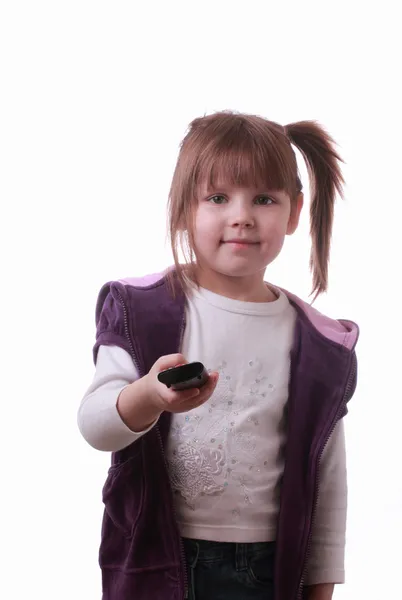 Una niña con una unidad de control remoto —  Fotos de Stock