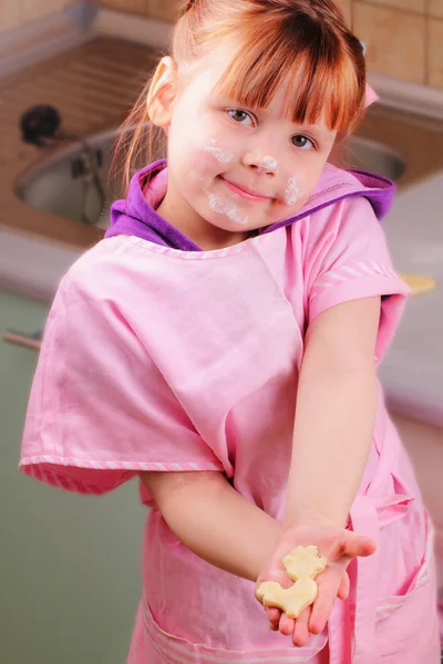 Lustiges kleines Mädchen mit einem Keks — Stockfoto