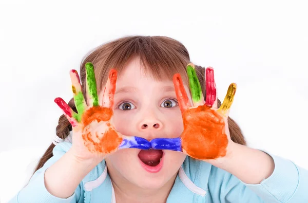 Little girl scares her colored hands — Stock Photo, Image