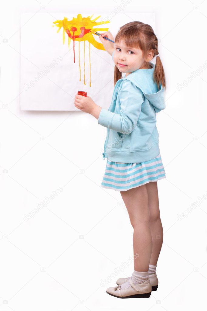 Little girl paints a picture