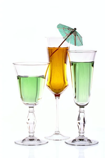 Three wineglasses are filled with colored beverages — Stock Photo, Image