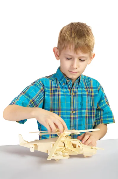 stock image A boy builds a wooden helicopter