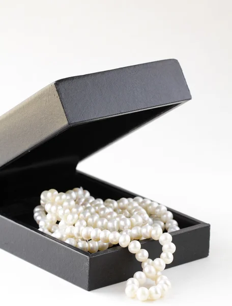 Macro pearls in black gift box — Stock Photo, Image