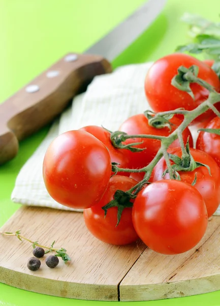 Fresh cherry tomatoes on a wooden board — Stock Photo, Image