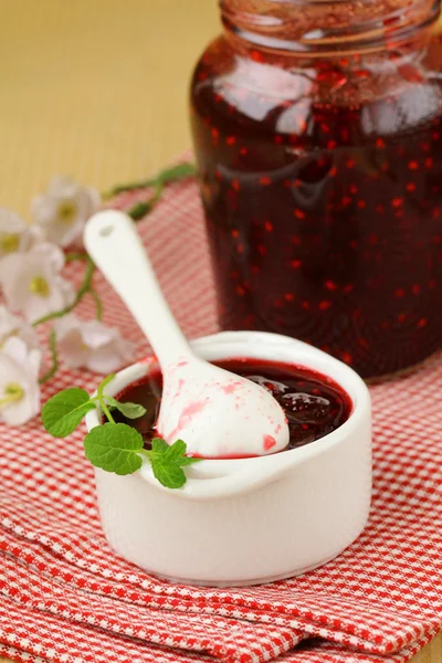 Raspberry jam on a wooden table, rustic style — Stock Photo, Image