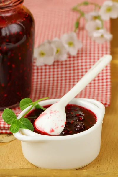 Raspberry jam on a wooden table, rustic style — Stock Photo, Image