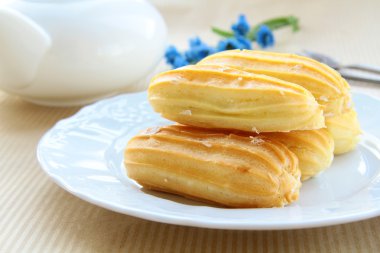 Cake profiteroles on a plate clipart