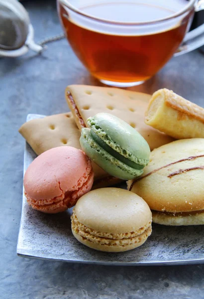 Traditional french macarons with tea set on the background — Stock Photo, Image