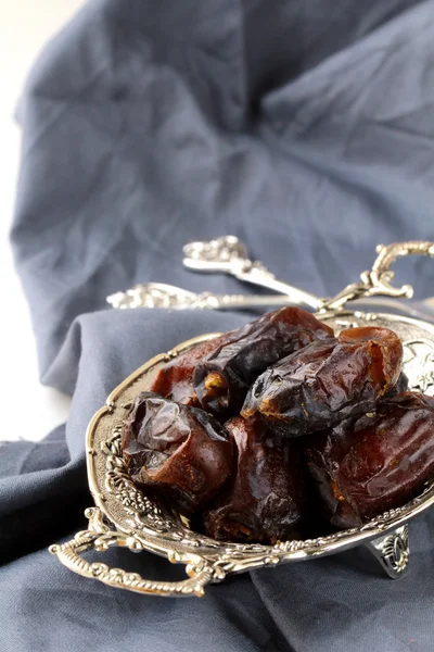 Plenty of ripped dates in silver cup — Stock Photo, Image