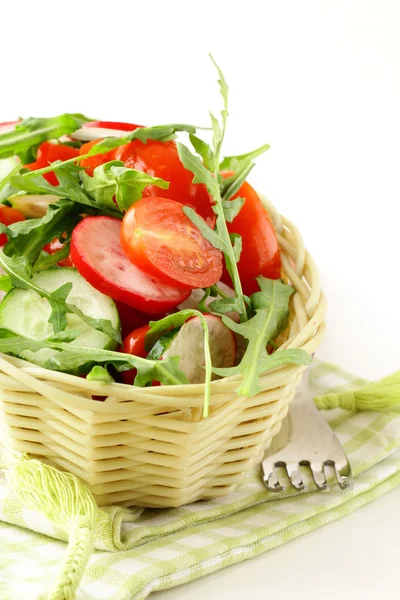 Salad with arugula and cherry tomatoes on a wooden plate — Stock Photo, Image