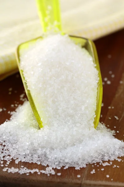 Heap of white sugar in spoon — Stock Photo, Image