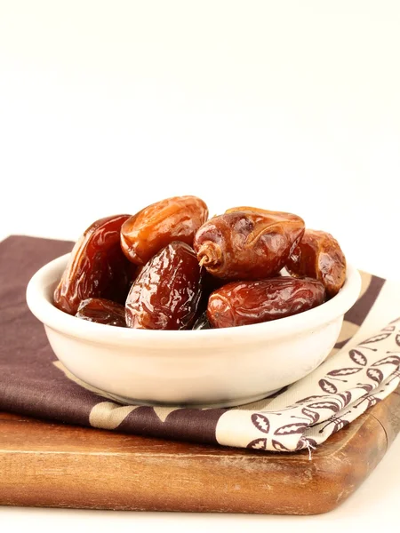 Plenty of ripped dates in white cup — Stock Photo, Image