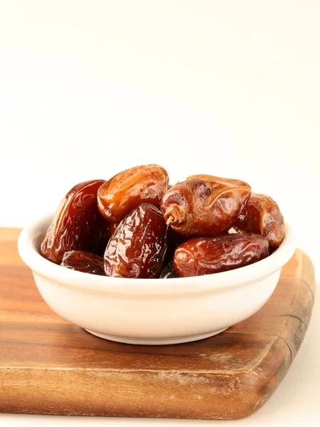 Plenty of ripped dates in white cup — Stock Photo, Image