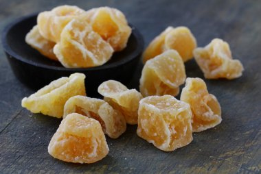 Candied ginger on a dark background clipart