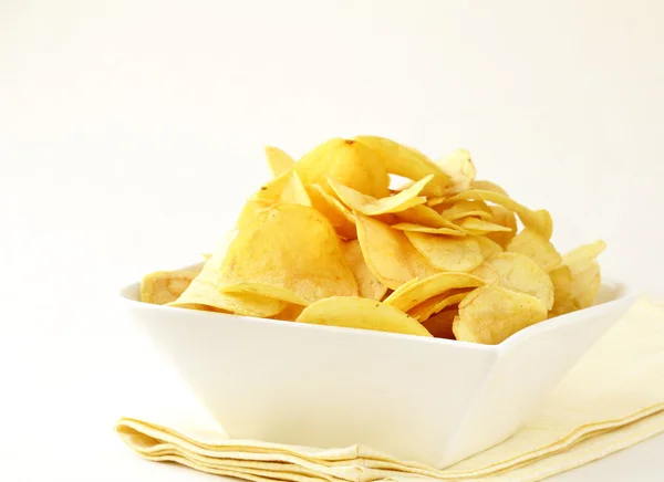 Potato chips in a white bowl — Stock Photo, Image