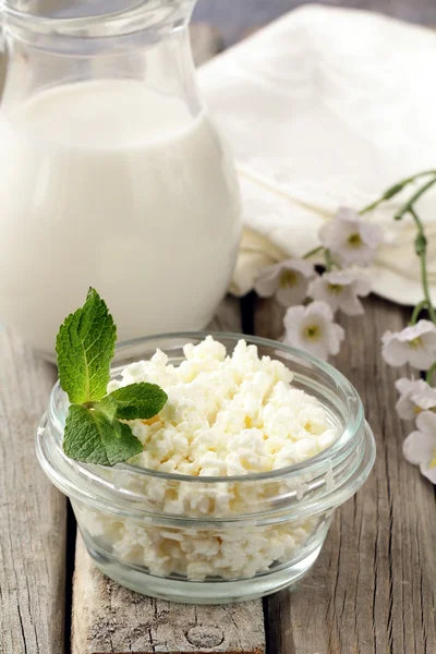 Natural dairy product cottage cheese on a wooden table, rustic style — Stock Photo, Image