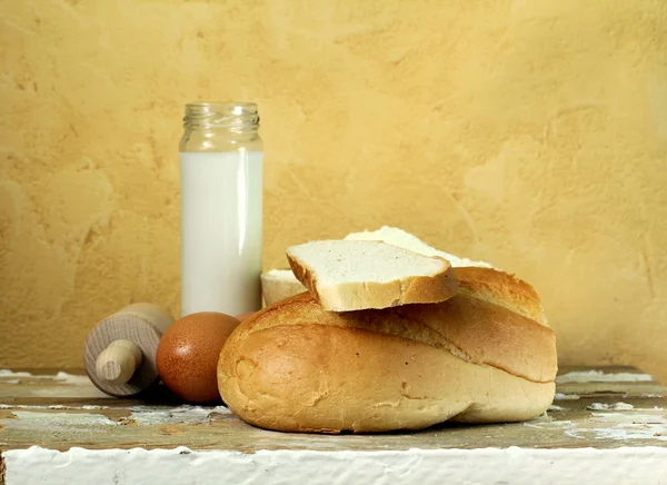 Still life - bread, milk, flour, eggs — Stock Photo, Image