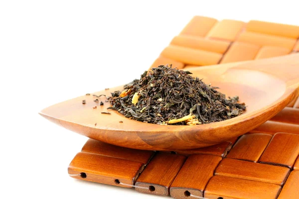 Fragrant black tea in wooden spoon — Stock Photo, Image