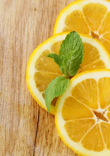 Three slices of lemon with mint leaf — Stock Photo, Image