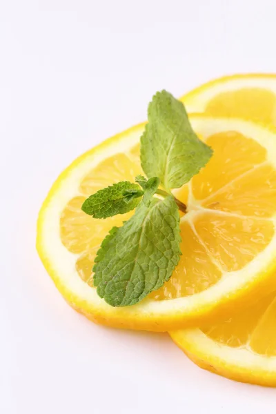 Stock image Three slices of lemon with mint leaf