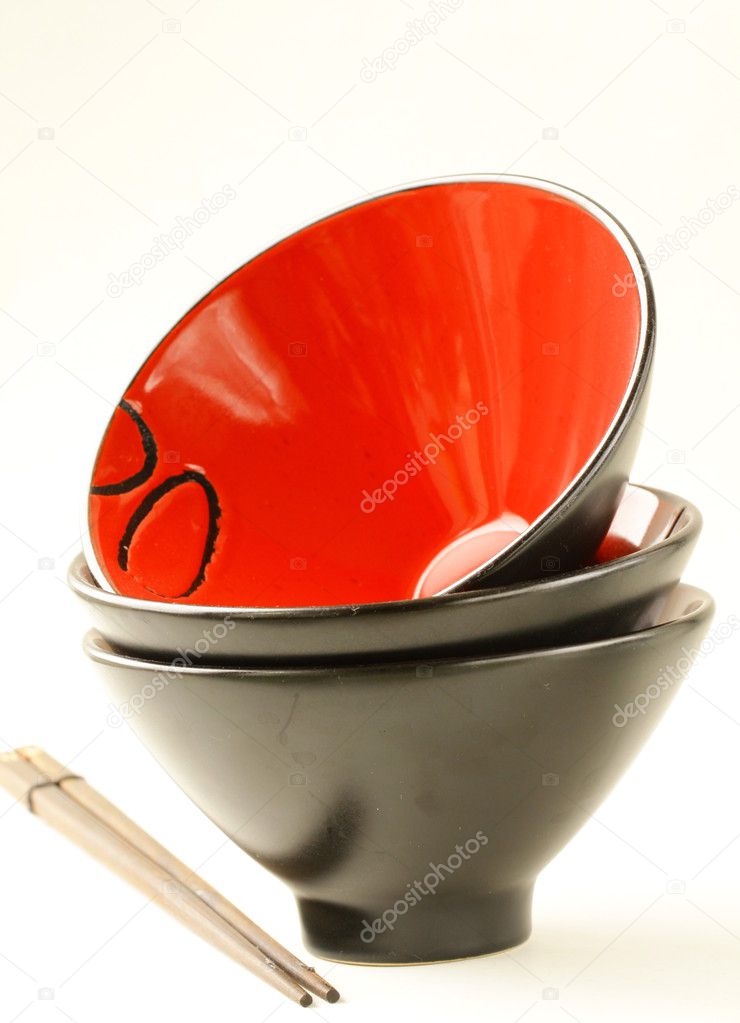 Asian cups and chopsticks on white background