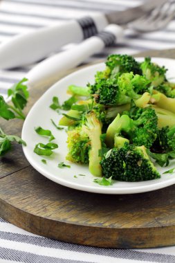 Salad with broccoli fried with spices clipart