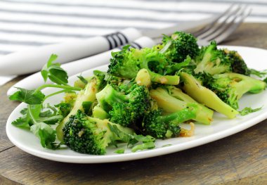 Salad with broccoli fried with spices clipart