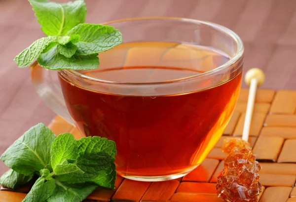 Cup of tea with mint on a brown background — Stock Photo, Image