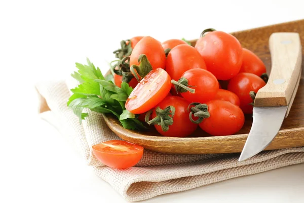 Cherry tomatoes on wooden plate — Stock Photo, Image
