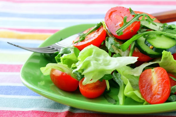 Salad with lettuce and cucumber, arugula and cherry tomatoes — Stock Photo, Image