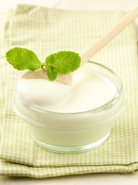 Fresh natural yoghurt in glass jar clipart