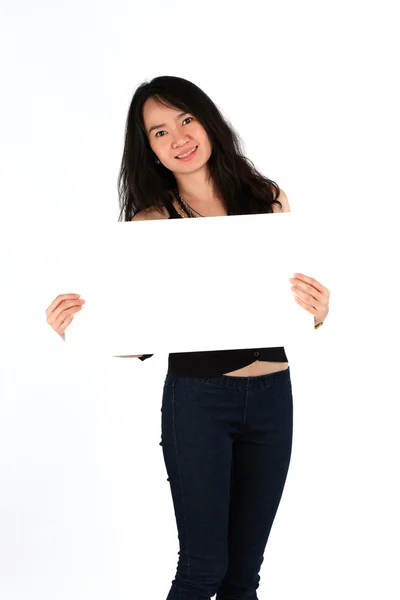 Beautiful young girl smiling holding blank card — Stock Photo, Image