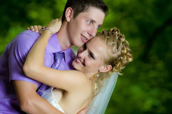 Noiva e noivo com um buquê de olhar um para o outro — Fotografia de Stock
