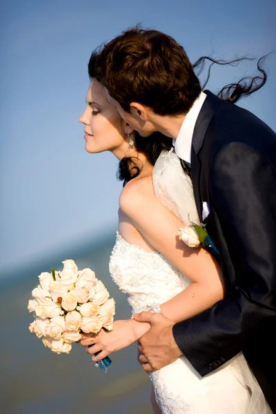 stock image Young beautiful pair of newlyweds on the sea