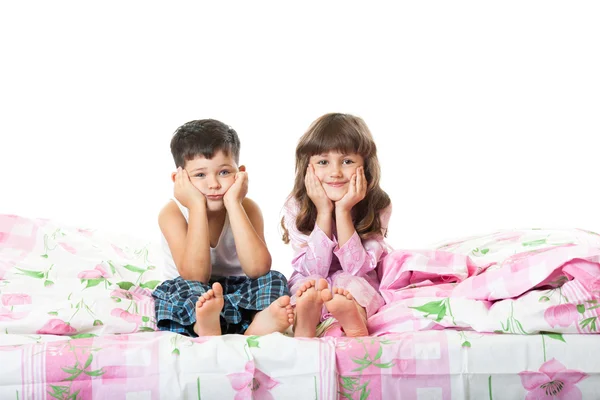 Little girl and boy sitting on the bed — Stock Photo, Image