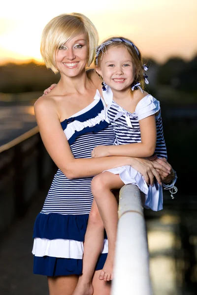 Mor och dotter spelar på flodbank — Stockfoto