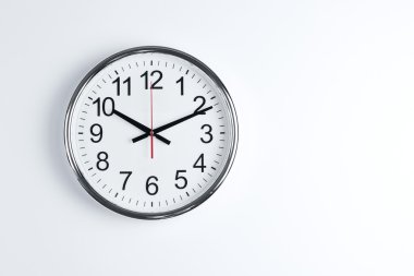 Clock hanging at the wall with copy space clipart