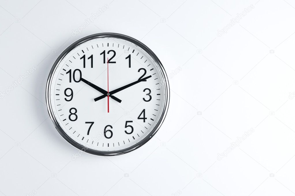 Clock hanging at the wall with copy space