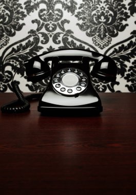 Vintage telephone at the desk clipart