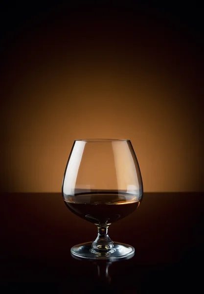 Glass of cognac with copy space — Stock Photo, Image