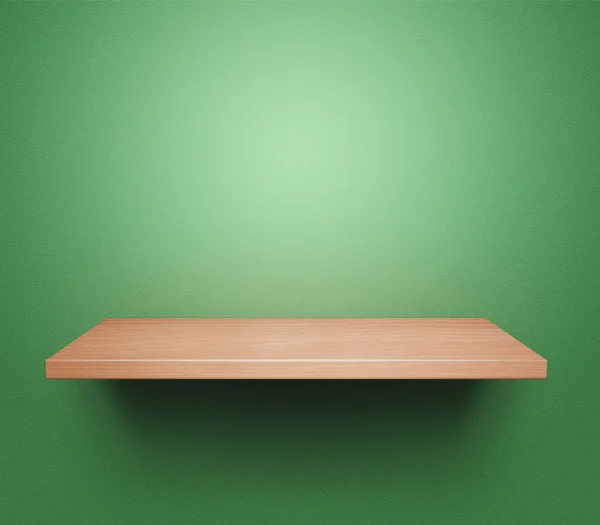 Lege plank bij groene muur — Stockfoto