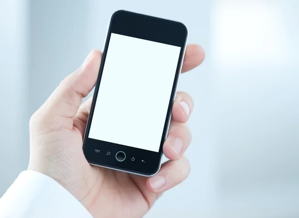 Telefone inteligente em branco na mão humana — Fotografia de Stock