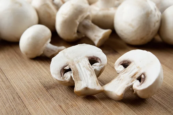 Fresh mushrooms at wooden board