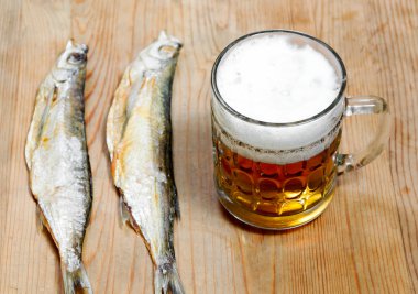 Dead dry salty fish and beer clipart