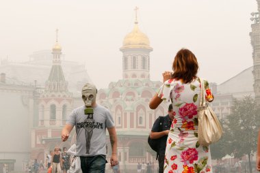 Tourists in a gas mask at the Red Square in Moscow clipart